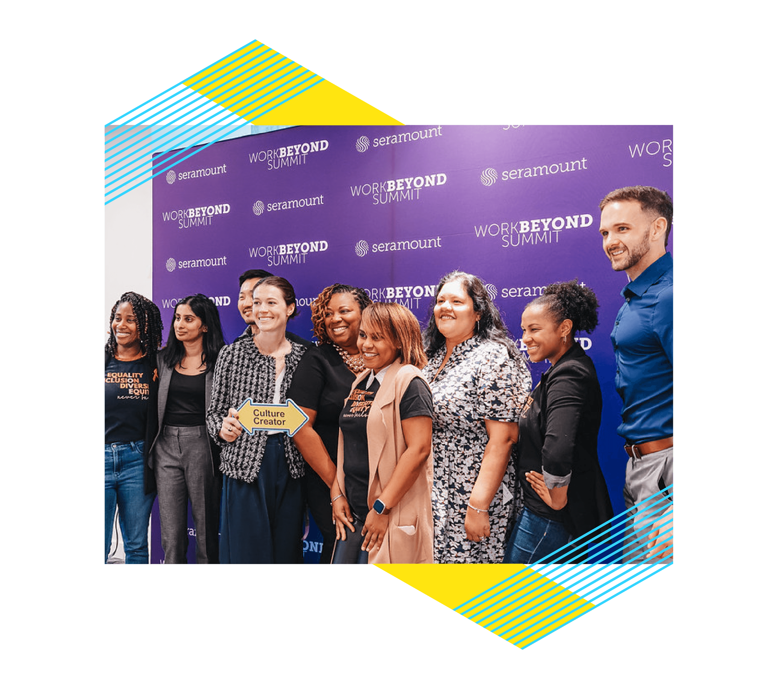 A group of 9 people standing in front of a WorkBeyond Summit branded backdrop