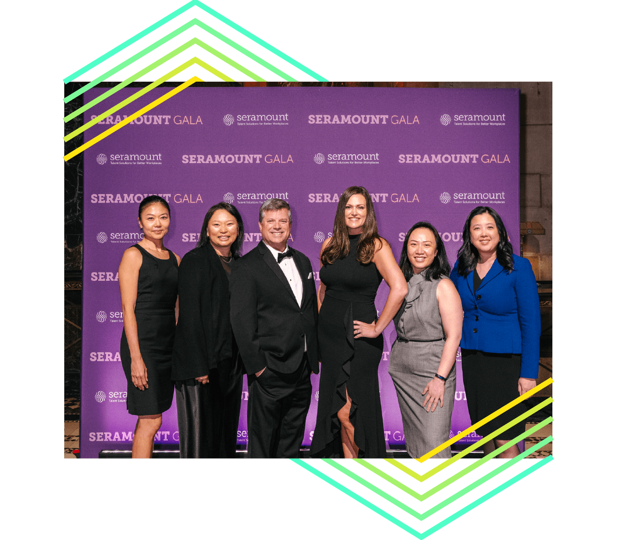 Six individuals in front of a Seramount branded dark purple backdrop